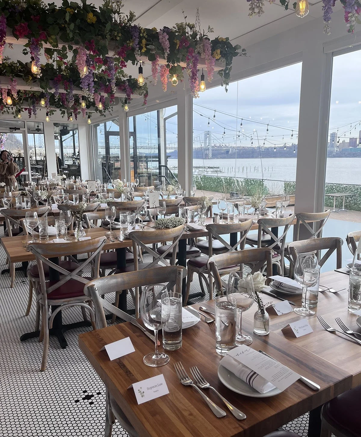 The DeNovo Edgewater dining room arranged for a daytime corporate event along the window wall.